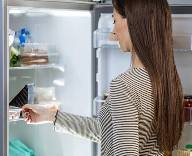 Fresh malai cream stored in an airtight container in the refrigerator