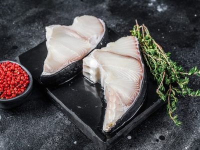 raw-shark-fish-steaks-board-black-background-top-view_89816-27215